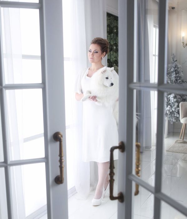 Woman performing a calm cardio movement in a studio with cyan light.